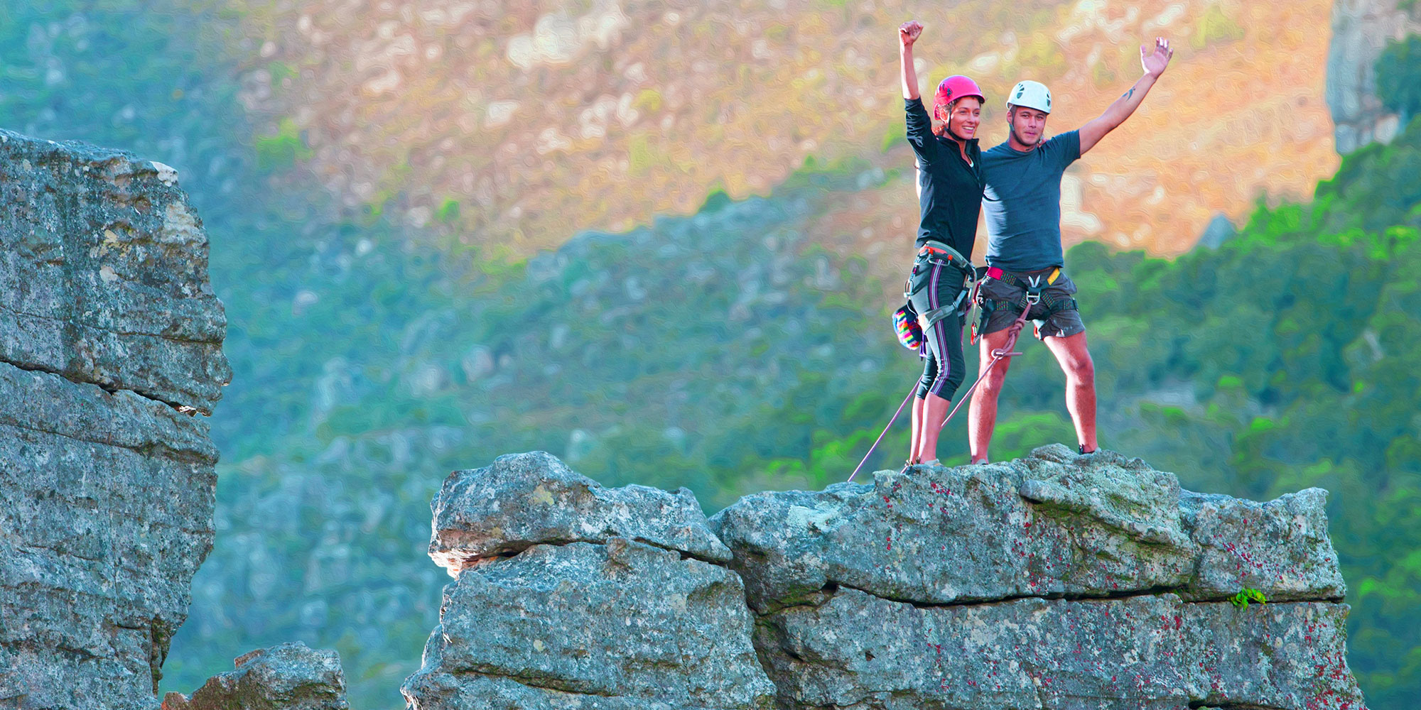 rock climbers reaching the top