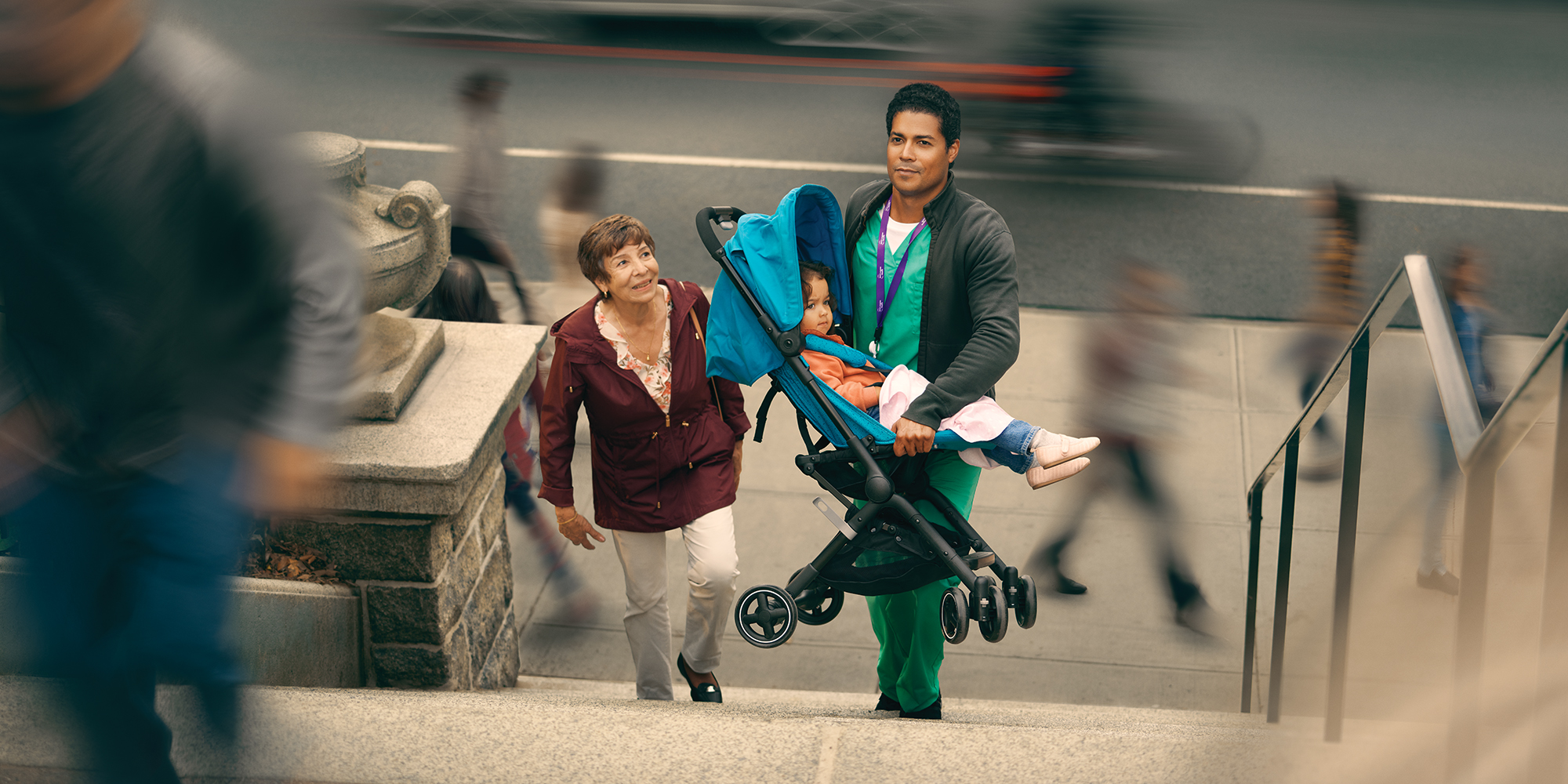 nurse carrying a stroller up stairs