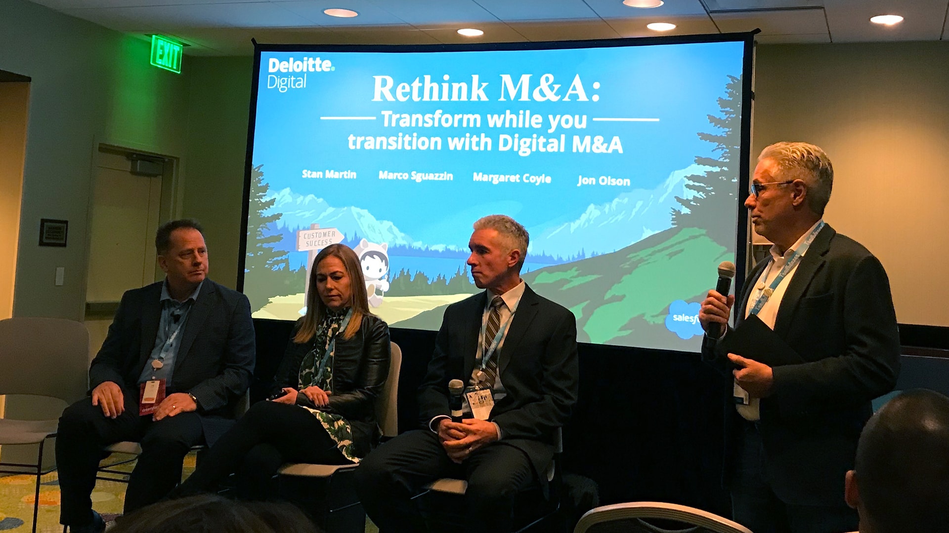 Four people giving presentation on Rethinking M&A at Dreamforce
