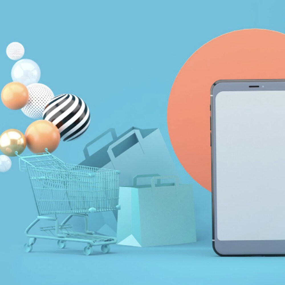 shopping cart and tablet on blue background